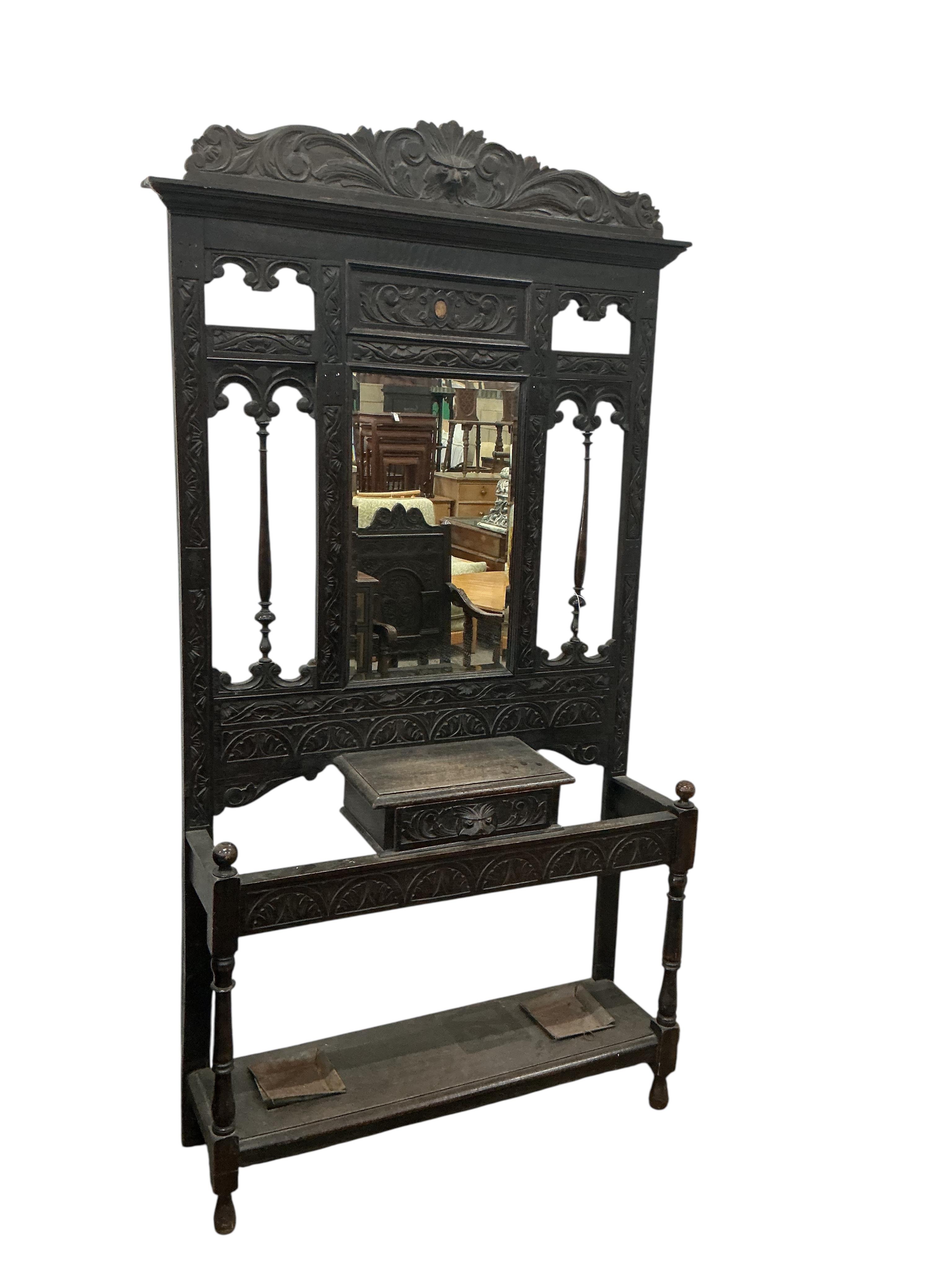 A late Victorian carved oak hallstand, width 108cm, height 210cm